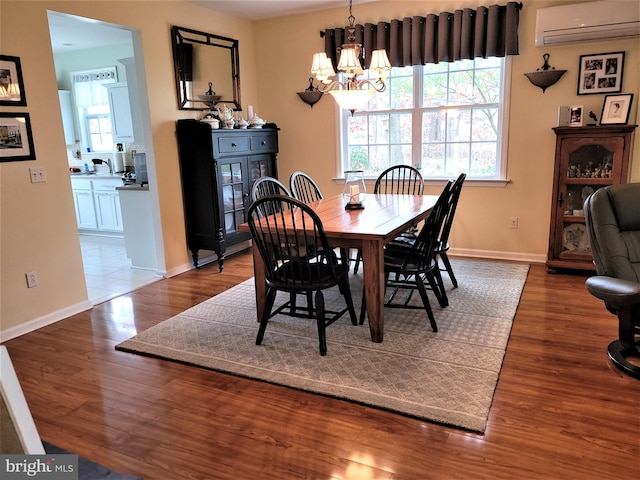 63 Briarwood Dr, Little Egg Harbor Twp, NJ 08087 - dining area with an AC wall unit, wood finished floors, a chandelier, and plenty of natural light