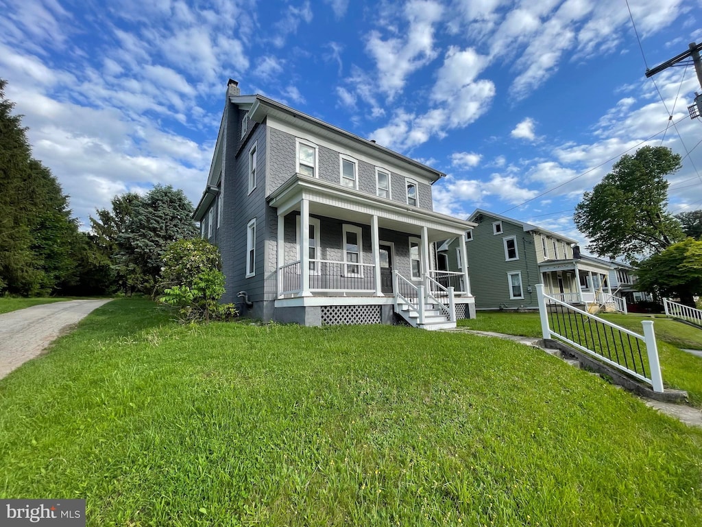 67 Main St, York, PA 17406 - view of front facade featuring a porch, a chimney, and a front yard