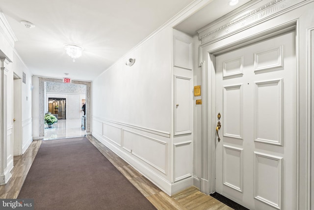 2700 Virginia Ave NW Unit 109, Washington, DC 20037 - hallway with wood finished floors, ornamental molding, and a decorative wall