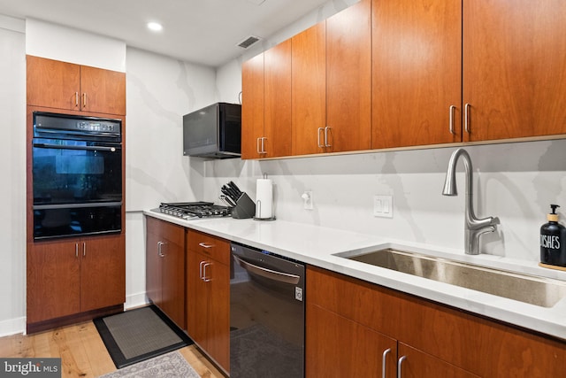 2700 Virginia Ave NW Unit 109, Washington, DC 20037 - kitchen with dishwasher, black oven, a warming drawer, stainless steel gas cooktop, and light countertops