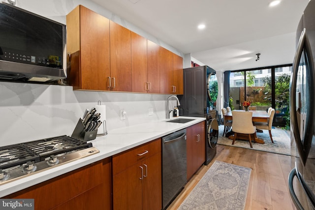 2700 Virginia Ave NW Unit 109, Washington, DC 20037 - kitchen with appliances with stainless steel finishes, light wood-type flooring, light countertops, brown cabinetry, and recessed lighting