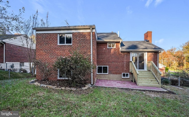 425 Saint Margarets Dr, Capitol Heights, MD 20743 - rear view of house with brick siding, a patio, and a chimney