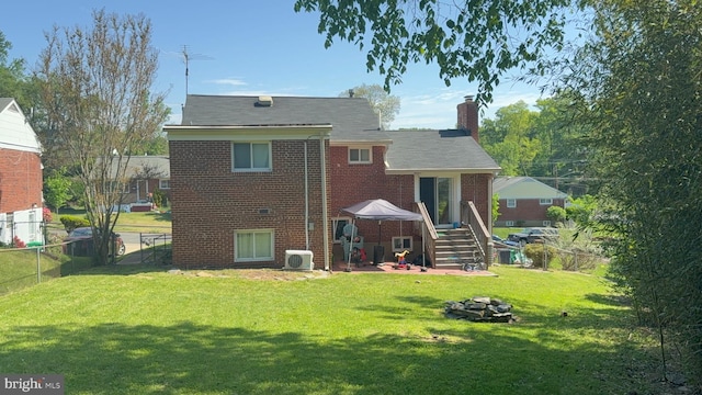 425 Saint Margarets Dr, Capitol Heights, MD 20743 - back of house with brick siding, a chimney, and a cooling unit