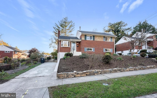 425 Saint Margarets Dr, Capitol Heights, MD 20743 - split level home featuring brick siding, a chimney, and concrete driveway