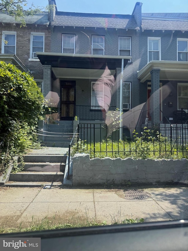 325 Bryant St NE, Washington, DC 20002 - townhome / multi-family property featuring brick siding, a fenced front yard, and mansard roof