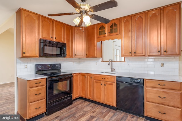 37 W Kapok, Newark, DE 19702 - kitchen featuring black appliances, a sink, wood finished floors, and light countertops