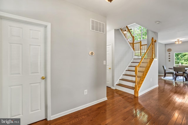 17542 Falls Pl, Round Hill, VA 20141 - stairs featuring a chandelier, hardwood / wood-style floors, and baseboards