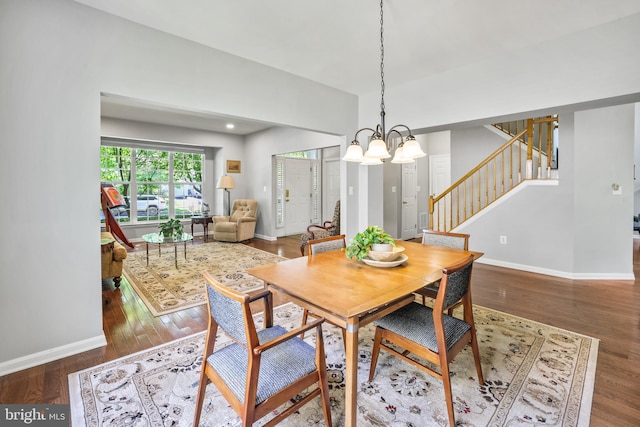 17542 Falls Pl, Round Hill, VA 20141 - dining area with stairs, a chandelier, wood finished floors, and baseboards