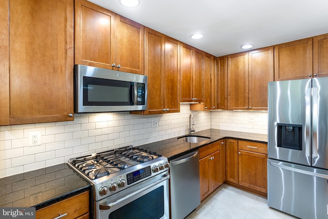 3603 Astoria Rd, Kensington, MD 20895 - kitchen featuring stainless steel appliances, dark stone counters, brown cabinets, tasteful backsplash, and recessed lighting