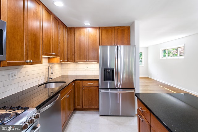 3603 Astoria Rd, Kensington, MD 20895 - kitchen featuring stainless steel appliances, dark stone countertops, tasteful backsplash, brown cabinets, and recessed lighting