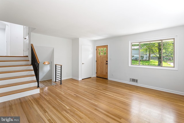 3603 Astoria Rd, Kensington, MD 20895 - unfurnished living room with light wood-style floors and stairs