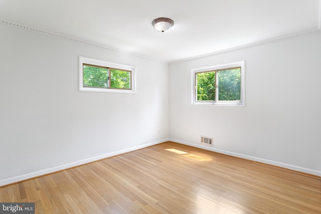 3603 Astoria Rd, Kensington, MD 20895 - spare room featuring healthy amount of natural light, light wood-style floors, and crown molding