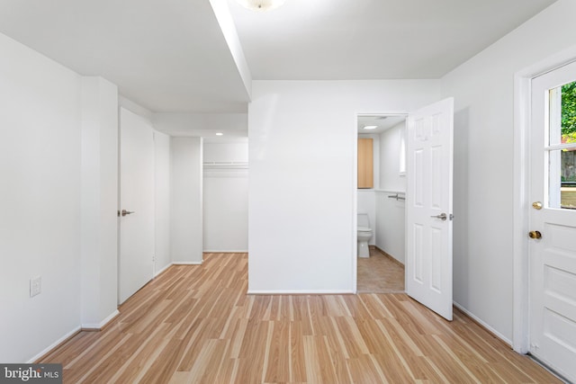 3603 Astoria Rd, Kensington, MD 20895 - unfurnished bedroom with light wood finished floors, ensuite bath, a walk in closet, and a closet