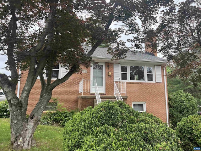 819 Elliott Ave, Charlottesville, VA 22902 - view of front of home featuring a chimney, brick siding, and roof with shingles