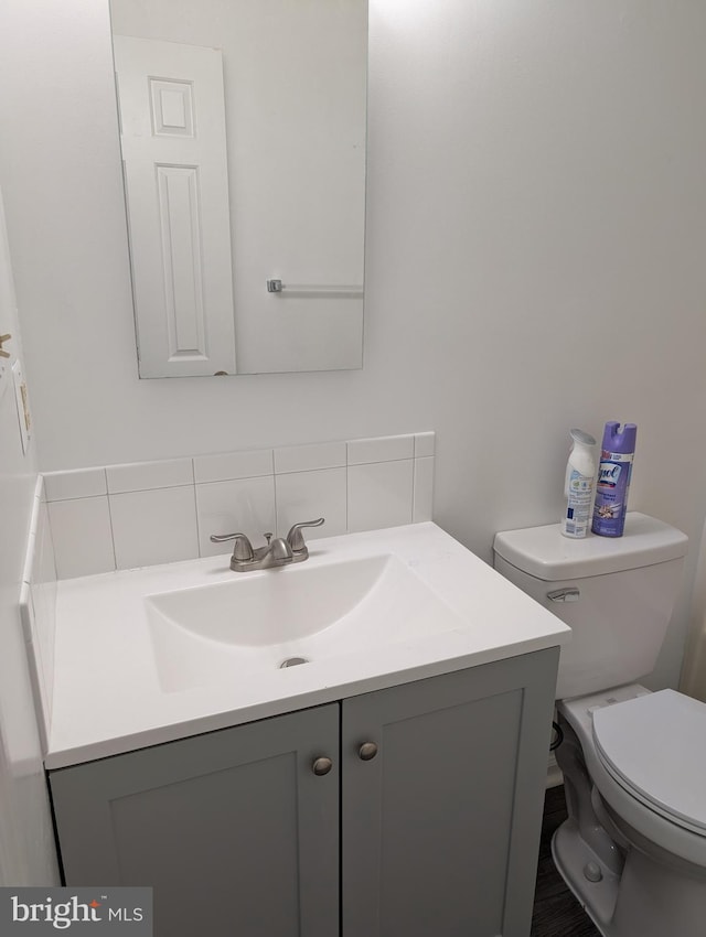 3002 Brinkley Station Dr, Temple Hills, MD 20748 - bathroom featuring vanity, decorative backsplash, and toilet