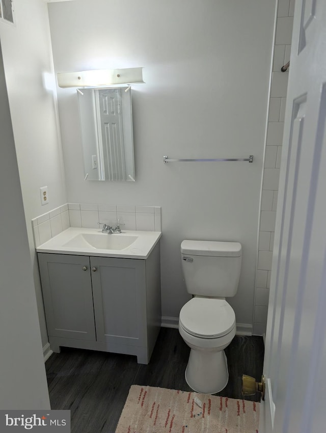 3002 Brinkley Station Dr, Temple Hills, MD 20748 - bathroom featuring wood finished floors, vanity, toilet, and baseboards