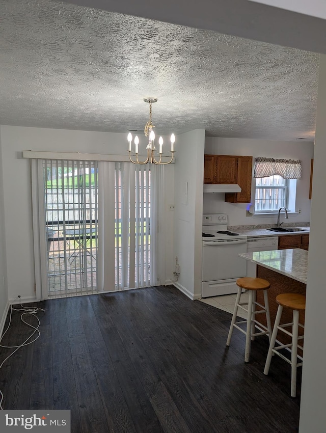 3002 Brinkley Station Dr, Temple Hills, MD 20748 - kitchen featuring white range with electric stovetop, a sink, under cabinet range hood, light countertops, and dark wood-style flooring