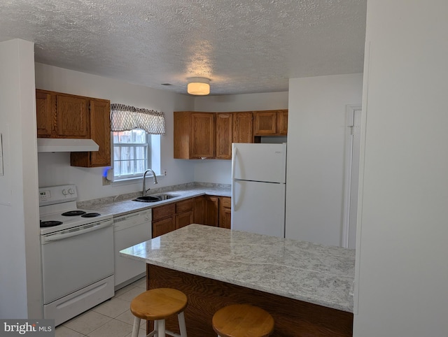 3002 Brinkley Station Dr, Temple Hills, MD 20748 - kitchen with white appliances, a sink, under cabinet range hood, brown cabinetry, and a kitchen breakfast bar