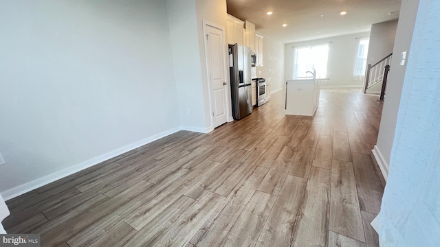 4904 Brookside Ct, Coopersburg, PA 18036 - unfurnished living room with wood finished floors, baseboards, recessed lighting, stairway, and a sink