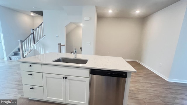 4904 Brookside Ct, Coopersburg, PA 18036 - kitchen featuring stainless steel dishwasher, a sink, white cabinets, light wood-style flooring, and a kitchen island with sink