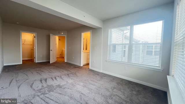 4904 Brookside Ct, Coopersburg, PA 18036 - unfurnished bedroom with a walk in closet, carpet floors, and baseboards