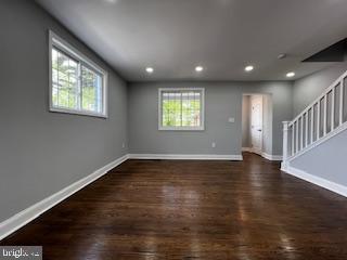 13 53rd Pl SE, Washington, DC 20019 - unfurnished living room featuring baseboards, wood finished floors, healthy amount of natural light, and recessed lighting