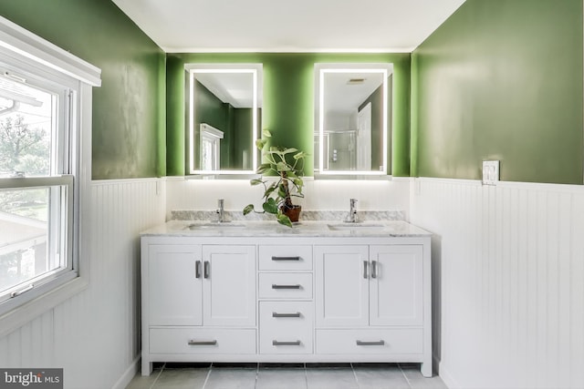 805 Islington St, Silver Spring, MD 20910 - full bath with wainscoting, double vanity, healthy amount of natural light, tile patterned flooring, and an enclosed shower