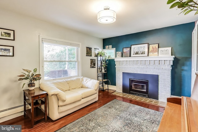 805 Islington St, Silver Spring, MD 20910 - living area featuring a baseboard radiator, wood finished floors, and a fireplace