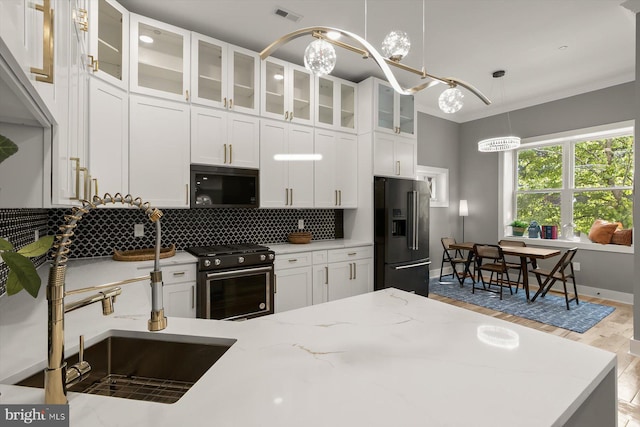 11921 Coronada Pl, Kensington, MD 20895 - kitchen featuring black microwave, stainless steel gas range, high end refrigerator, decorative backsplash, and white cabinets