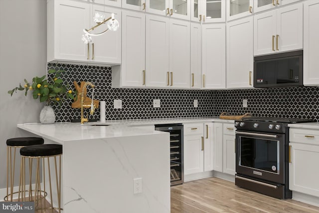 11921 Coronada Pl, Kensington, MD 20895 - kitchen with black appliances, wine cooler, white cabinetry, and a kitchen bar