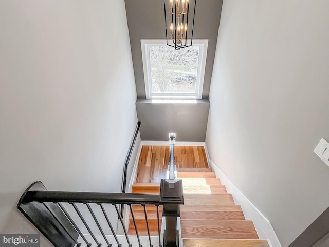 11921 Coronada Pl, Kensington, MD 20895 - stairs featuring baseboards, a chandelier, and wood finished floors