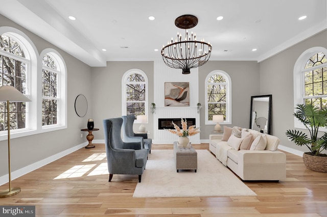 11921 Coronada Pl, Kensington, MD 20895 - living area with light wood-style floors, a glass covered fireplace, recessed lighting, crown molding, and a chandelier