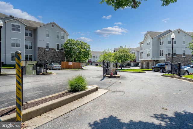 7432 Hindon Cir Unit B1-204, Windsor Mill, MD 21244 - view of asphalt street with a residential view, curbs, street lighting, and a gated entry