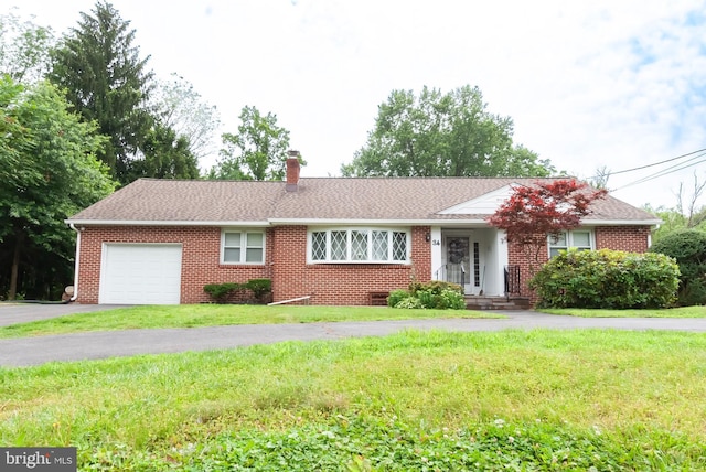 34 Georgetown Rd, Bordentown, NJ 08505 - ranch-style house with an attached garage, brick siding, a front lawn, and a chimney