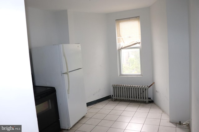 1501 Druid Hill Ave, Baltimore, MD 21217 - kitchen featuring radiator heating unit, black range with electric cooktop, and freestanding refrigerator