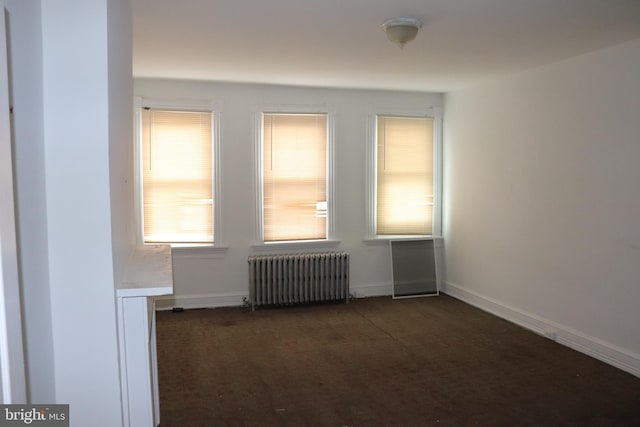 1501 Druid Hill Ave, Baltimore, MD 21217 - empty room with radiator heating unit, dark colored carpet, and baseboards