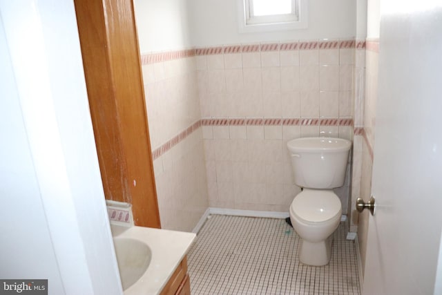 1501 Druid Hill Ave, Baltimore, MD 21217 - bathroom with toilet, tile walls, vanity, and tile patterned floors