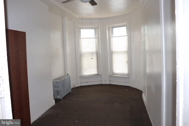 1501 Druid Hill Ave, Baltimore, MD 21217 - carpeted empty room with radiator heating unit and a ceiling fan
