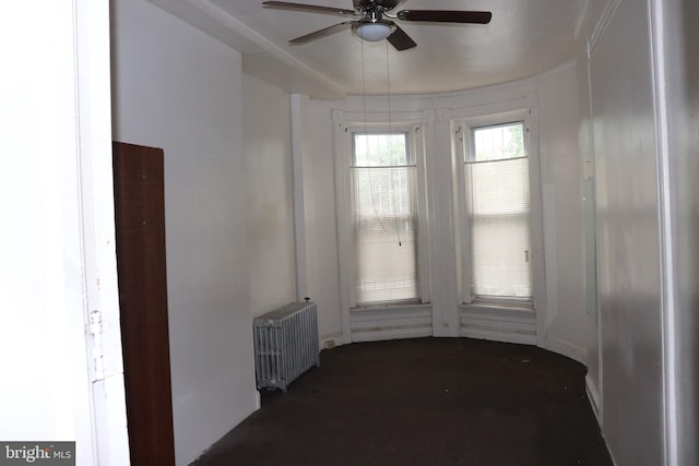 1501 Druid Hill Ave, Baltimore, MD 21217 - spare room featuring radiator heating unit, ceiling fan, and carpet