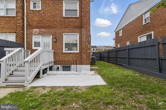 1964 Guy Way, Dundalk, MD 21222 - rear view of property with central AC unit, brick siding, and a patio