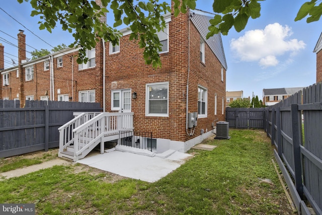 1964 Guy Way, Dundalk, MD 21222 - back of property featuring central AC unit, a patio area, and brick siding