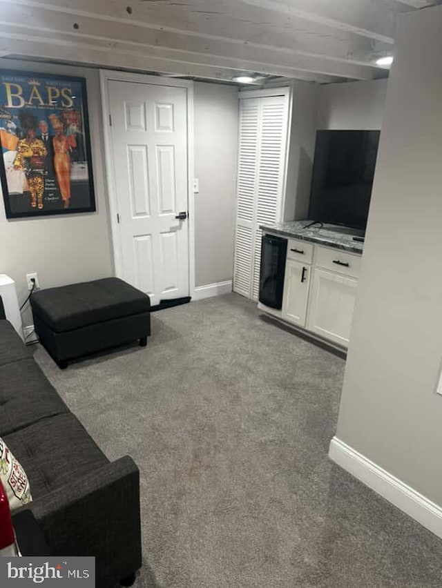 1528 N Ellamont St, Baltimore, MD 21216 - living room with baseboards, carpet floors, and wine cooler