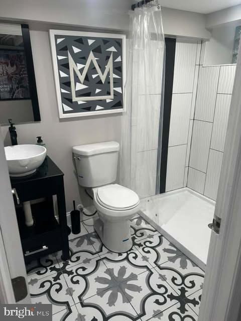 1528 N Ellamont St, Baltimore, MD 21216 - bathroom with toilet, a stall shower, vanity, and tile patterned flooring