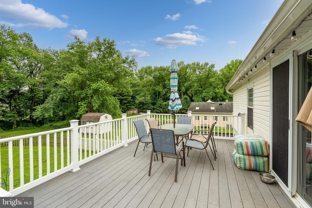315 Robinhood Rd, Havre De Grace, MD 21078 - wooden deck with outdoor dining area, a lawn, and view of wooded area