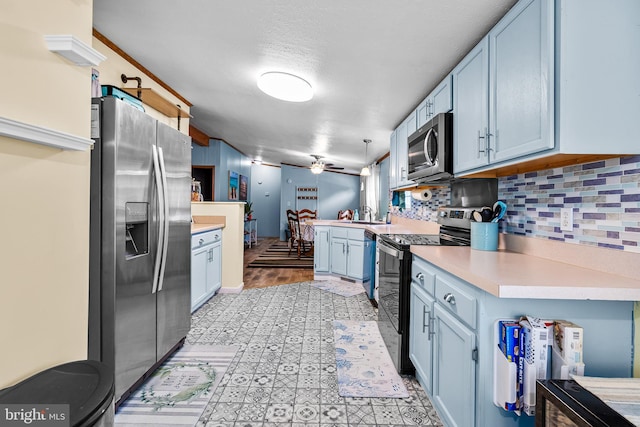 315 Robinhood Rd, Havre De Grace, MD 21078 - kitchen featuring appliances with stainless steel finishes, light countertops, a peninsula, decorative backsplash, and a ceiling fan