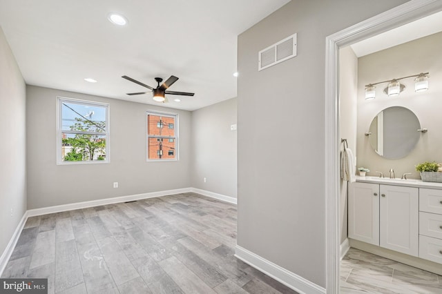 518 N Patterson Park Ave, Baltimore, MD 21205 - spare room with a ceiling fan, a sink, baseboards, recessed lighting, and light wood-type flooring