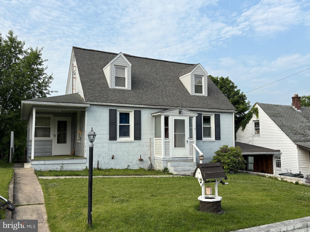 1016 Beechwood Dr, Hagerstown, MD 21742 - cape cod house with concrete block siding, a front yard, and roof with shingles