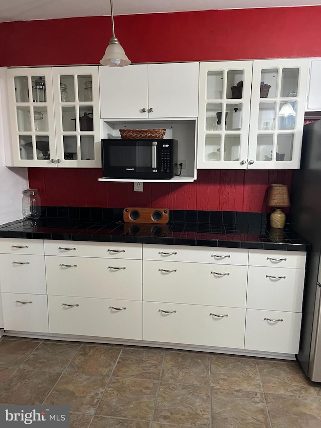 896 Hershey Heights Rd, Hanover, PA 17331 - kitchen featuring black microwave, tile countertops, and white cabinets