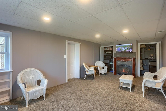 896 Hershey Heights Rd, Hanover, PA 17331 - living area with carpet, a lit fireplace, and a paneled ceiling