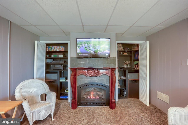 896 Hershey Heights Rd, Hanover, PA 17331 - living area featuring carpet, a lit fireplace, and a paneled ceiling